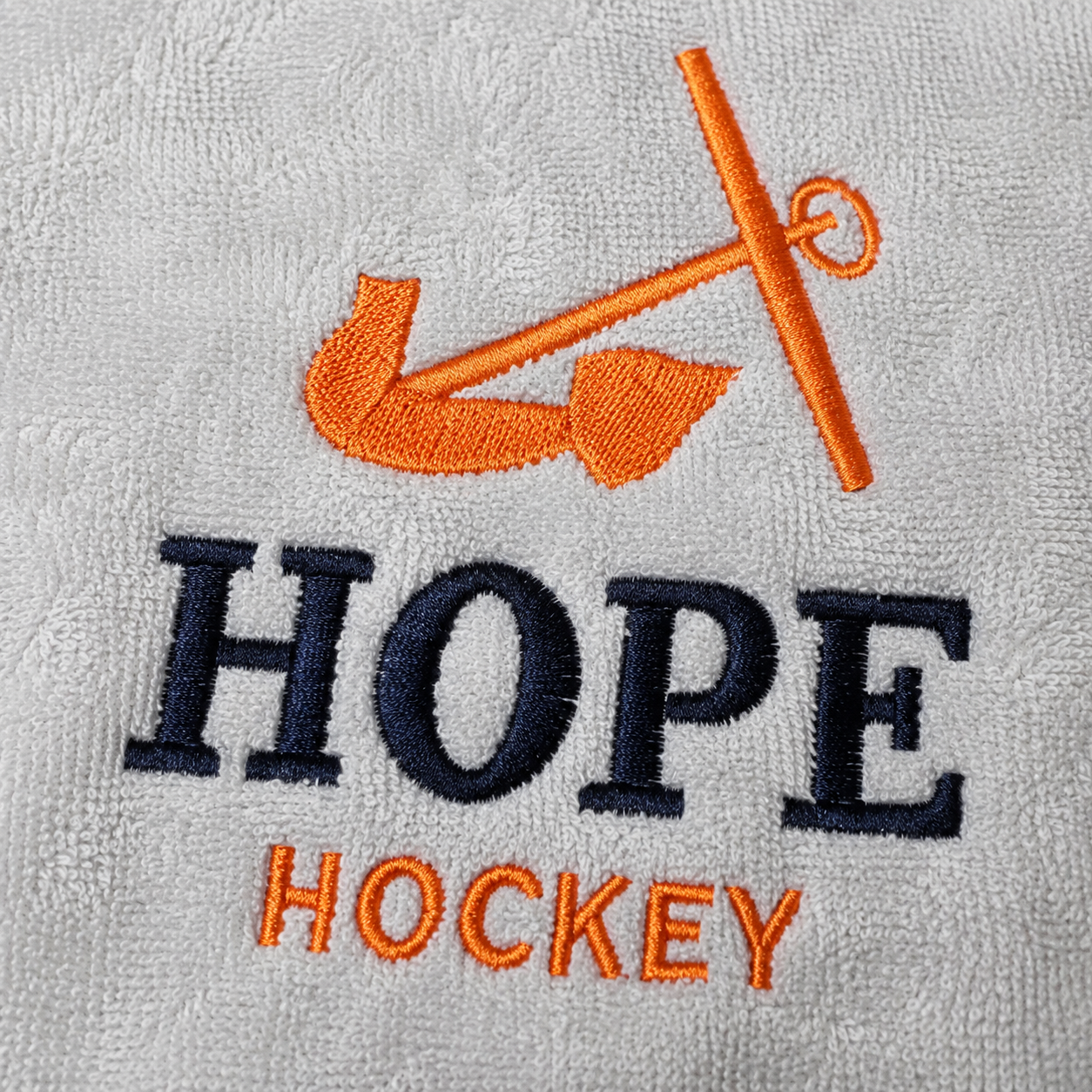 Close-up of premium embroidery on a custom golf towel showing high-quality stitching and professional logo detail.